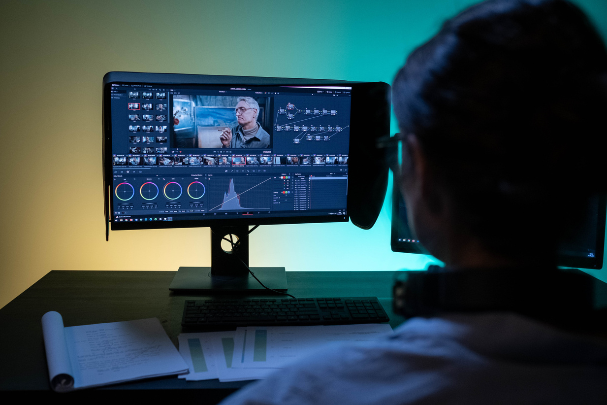 Backview of a Female Editor working on a Computer